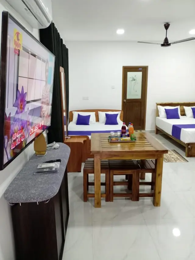Large suite with a dining table for four, several beds and a TV unit