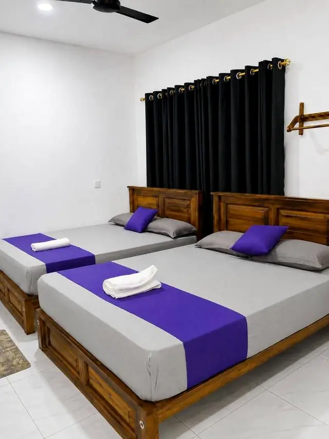 Twin room with two beds, violet runners and fresh towels